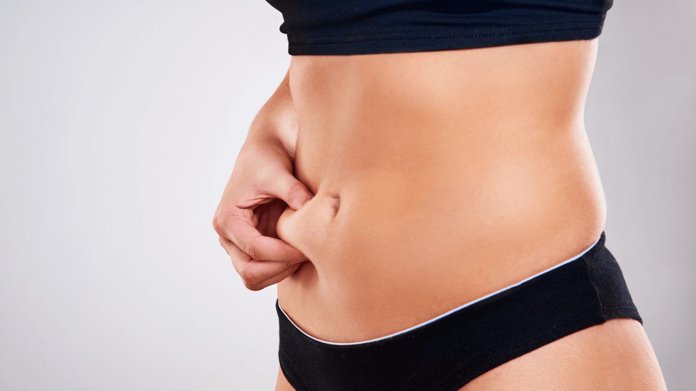 woman pinching her belly skin